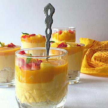 This Mango Cheesecake Trifle is very easy to make and super delicious. Most important part is that it is a No-Cook and No-Bake Recipe. It is a perfect dessert for your parties and get-togethers. #mangorecipes #cheesescake #mangocheesecake #nobakecheesecake #nocookcheesecake #triflerecipes #easydessert #mangodessert #cheesecake #summerdessert #nutfreedessert #easytrifle #partydessert #easycheesecake #nocookdessert 