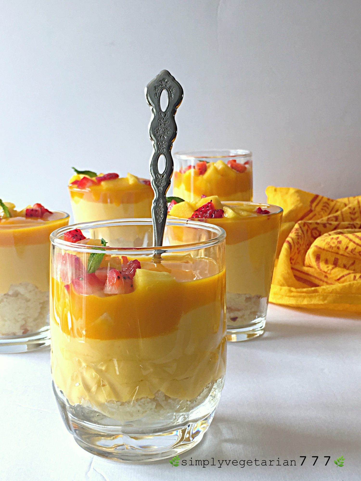 This Mango Cheesecake Trifle is very easy to make and super delicious. Most important part is that it is a No-Cook and No-Bake Recipe. It is a perfect dessert for your parties and get-togethers. #mangorecipes #cheesescake #mangocheesecake #nobakecheesecake #nocookcheesecake #triflerecipes #easydessert #mangodessert #cheesecake #summerdessert #nutfreedessert #easytrifle #partydessert #easycheesecake #nocookdessert 