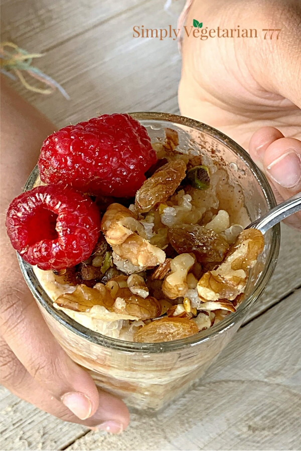 Vegan Quinoa Porridge for Breakfast topped with fresh berries, nuts and maple syrup.